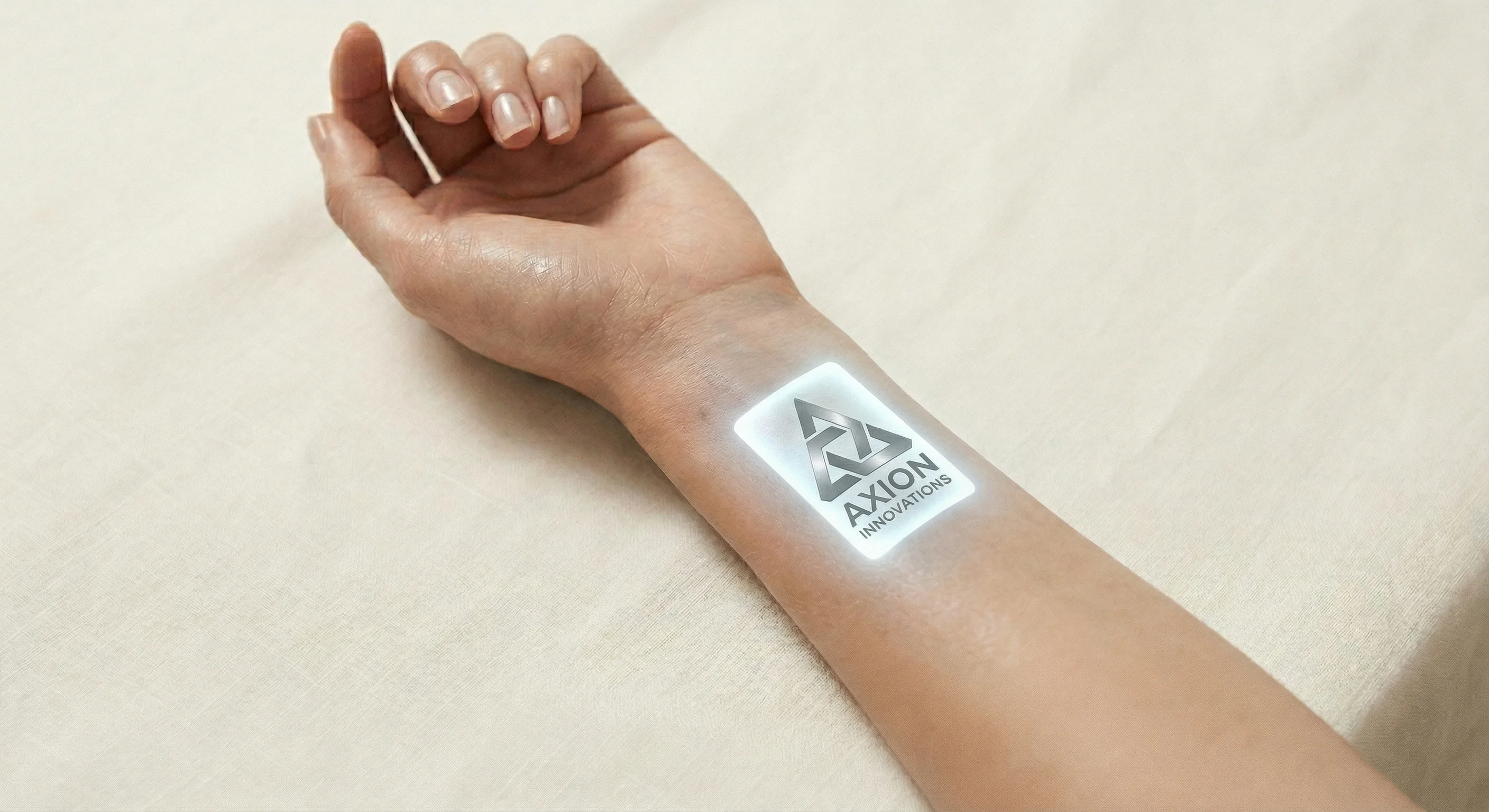 A close-up editorial photograph of a person's inner forearm on a clean white surface, with a faint glowing rectangular display visible beneath the skin